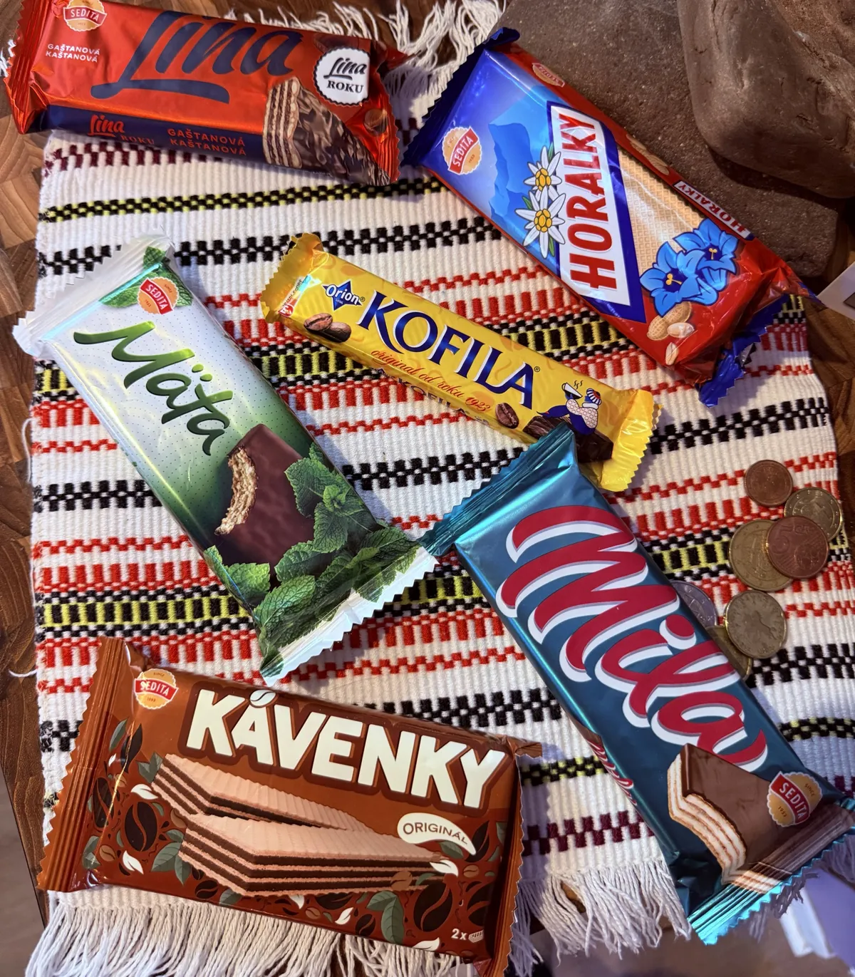 Slovak and Czech wafers and chocolate bars — Lina, Horalky, Kofila, Mäta, Mila and Kávenky — on a woven striped towel
