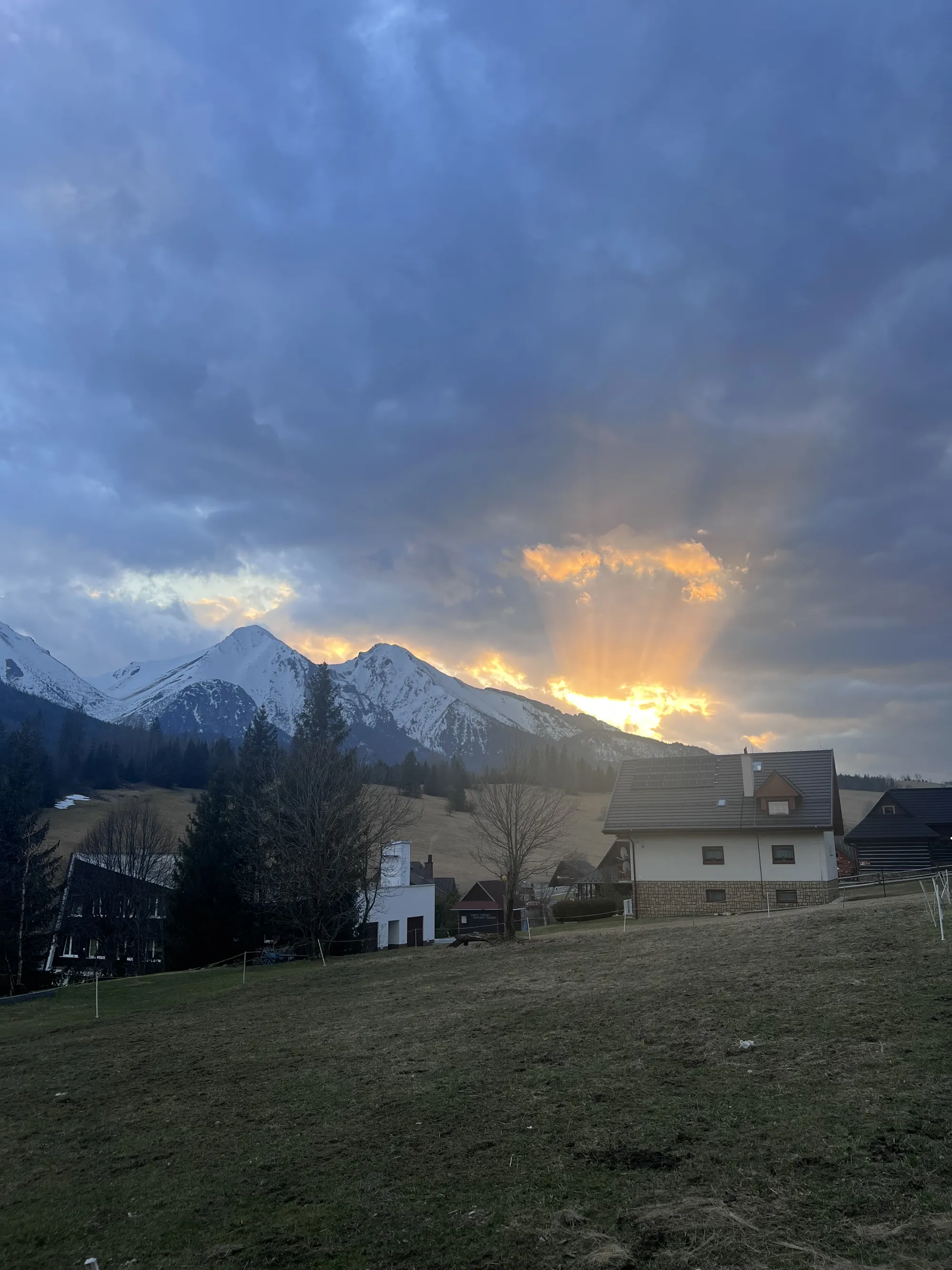 Sunset over the snowy High Tatras mountains behind a Slovak village